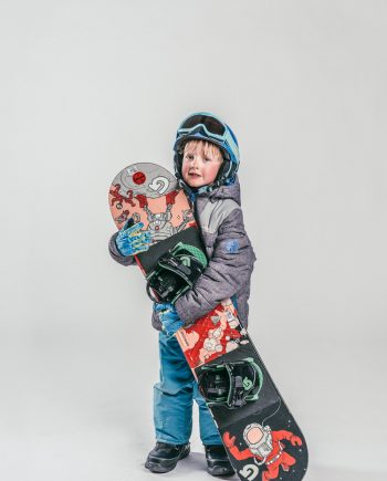 Oxygène Ski & Snowboard School Child Holding Snowboard 3